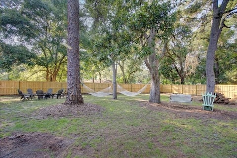 Very large, fenced in backyard with two hammocks, patio with picnic table, gas grill, and additional seating.