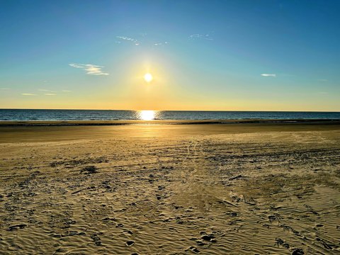 Sunrise over the flat, hard-packed sand a block from the cottage.
